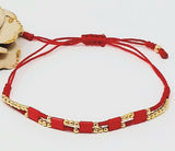 Double adjustable thread bracelet with gold plate balls. Red , Gold